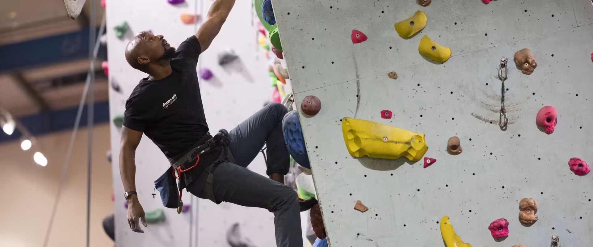 Climber hanging from one arm on an overhang 